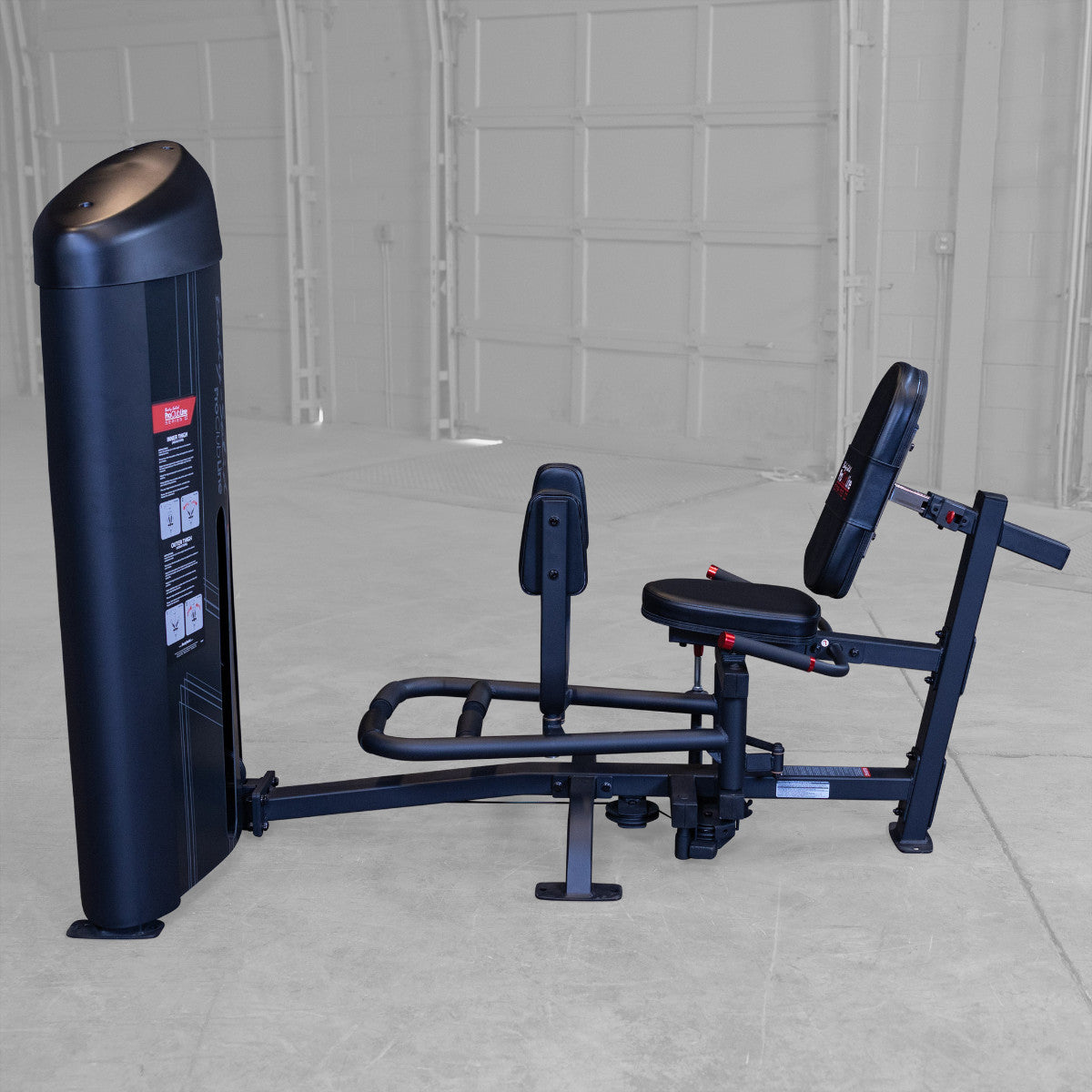 Body-Solid S2IOTX Pro ClubLine Series 2 Dual Inner Outer Thigh Machine in gym with woman exercising