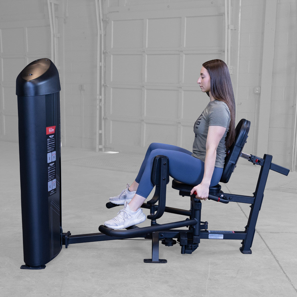 Body-Solid S2IOTX Pro ClubLine Series 2 Dual Inner Outer Thigh Machine in gym with woman exercising