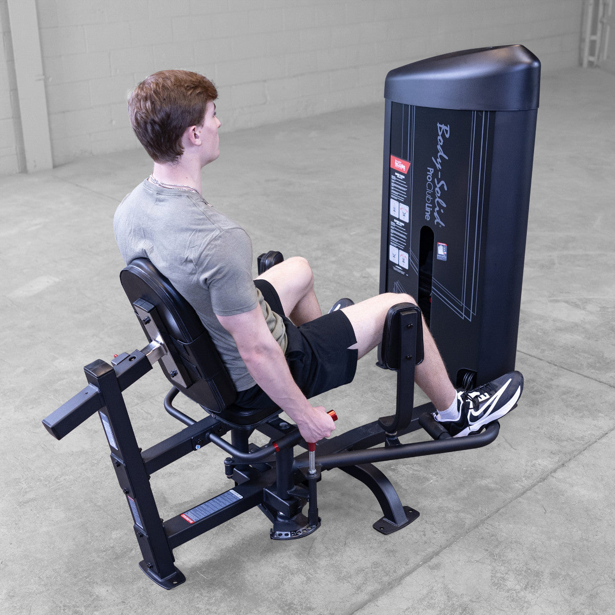 Body-Solid S2IOTX Pro ClubLine Series 2 Dual Inner Outer Thigh Machine in gym with man exercising
