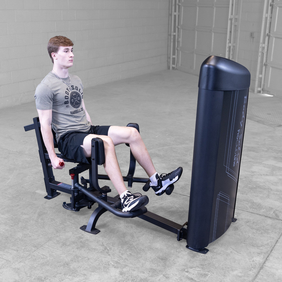 Body-Solid S2IOTX Pro ClubLine Series 2 Dual Inner Outer Thigh Machine in gym with man exercising