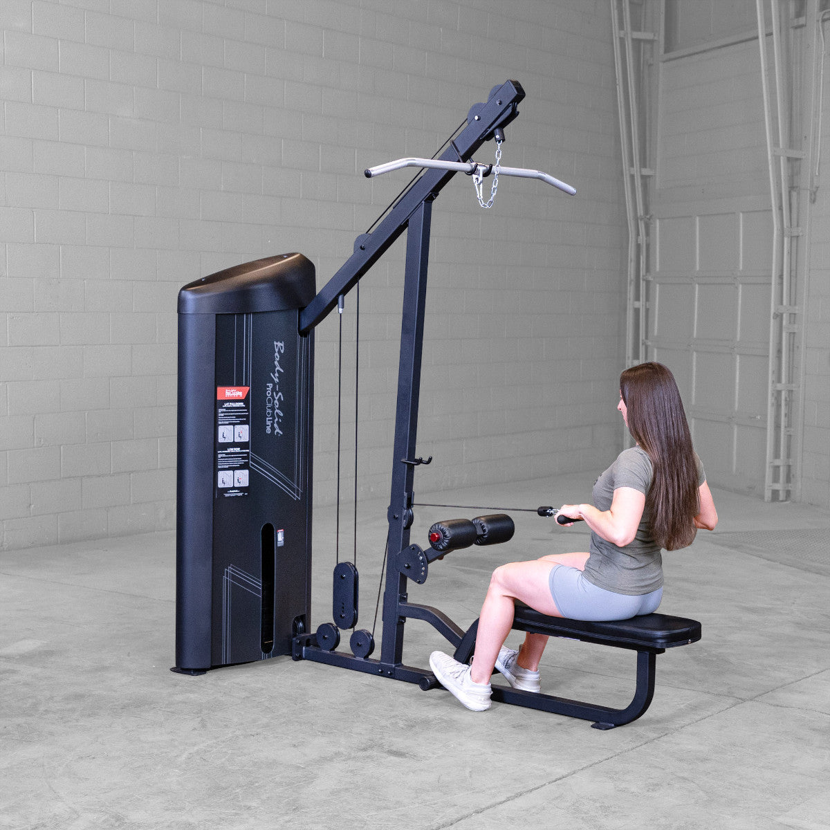 Body-Solid S2LATX Pro ClubLine Series 2 Dual Lat & Seated Row Machine with woman exercising