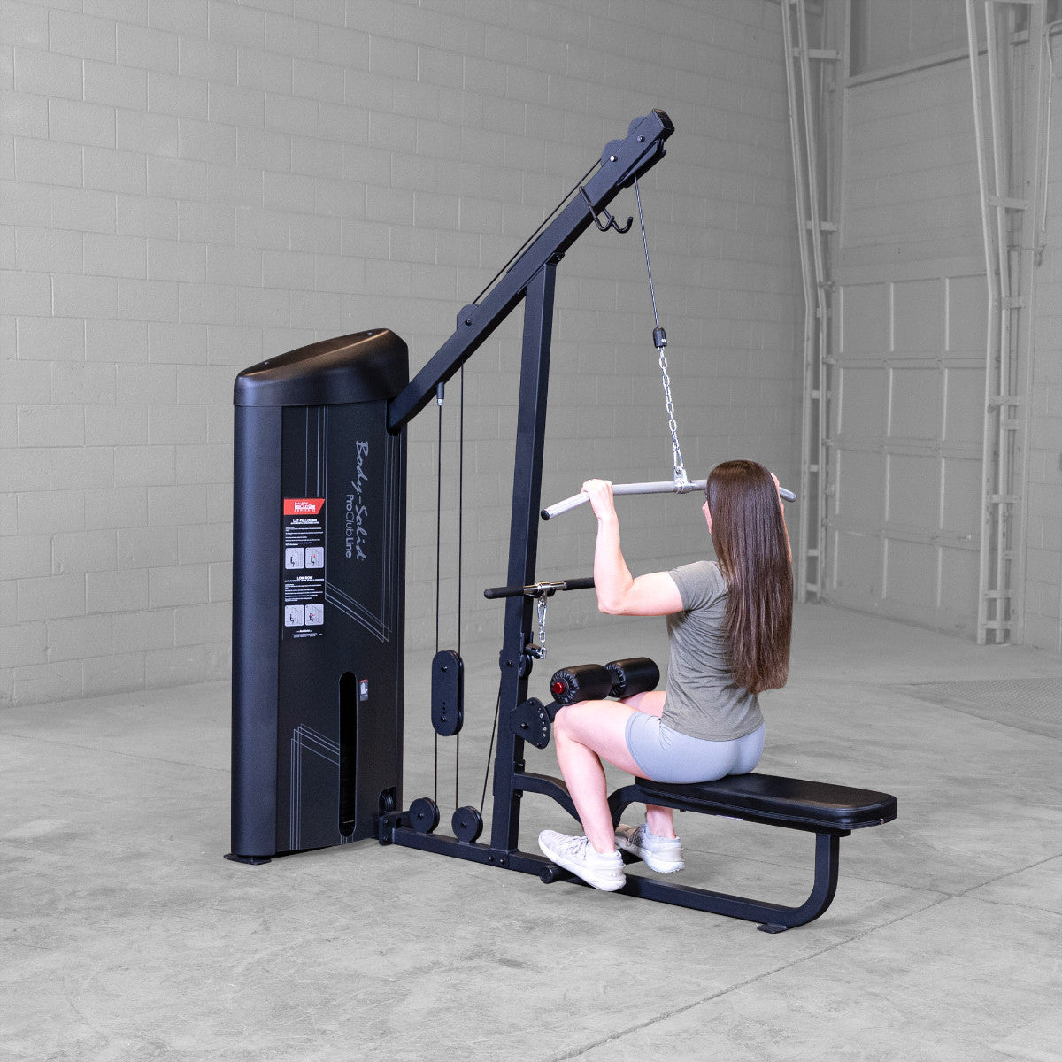 Body-Solid S2LATX Pro ClubLine Series 2 Dual Lat & Seated Row Machine with woman exercising