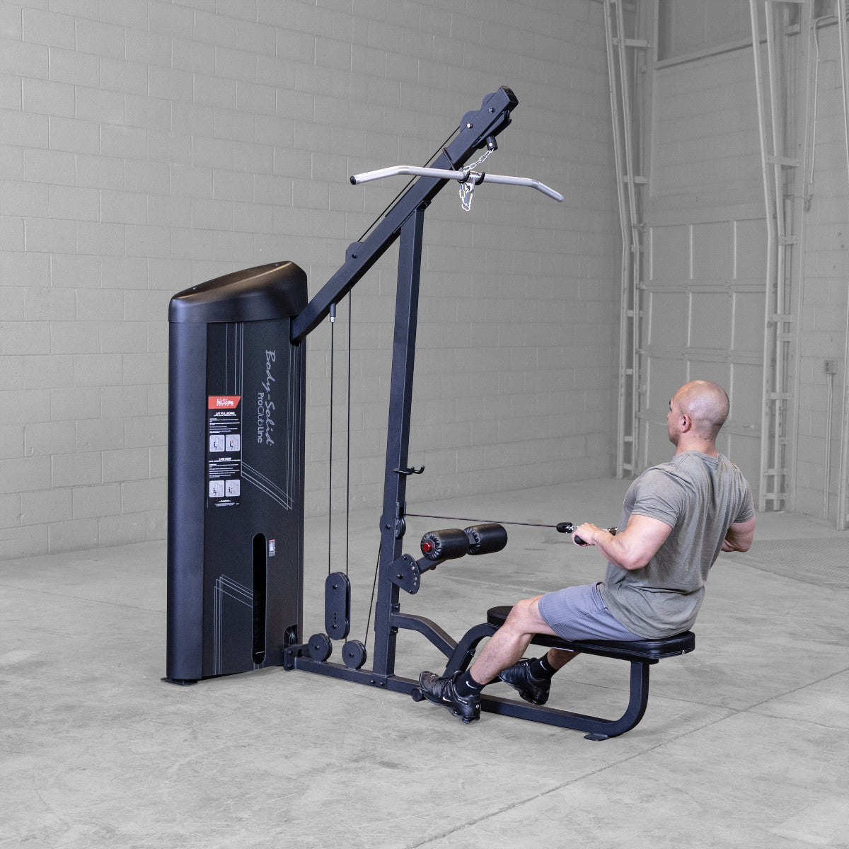 Body-Solid S2LATX Pro ClubLine Series 2 Dual Lat & Seated Row Machine with man exercising