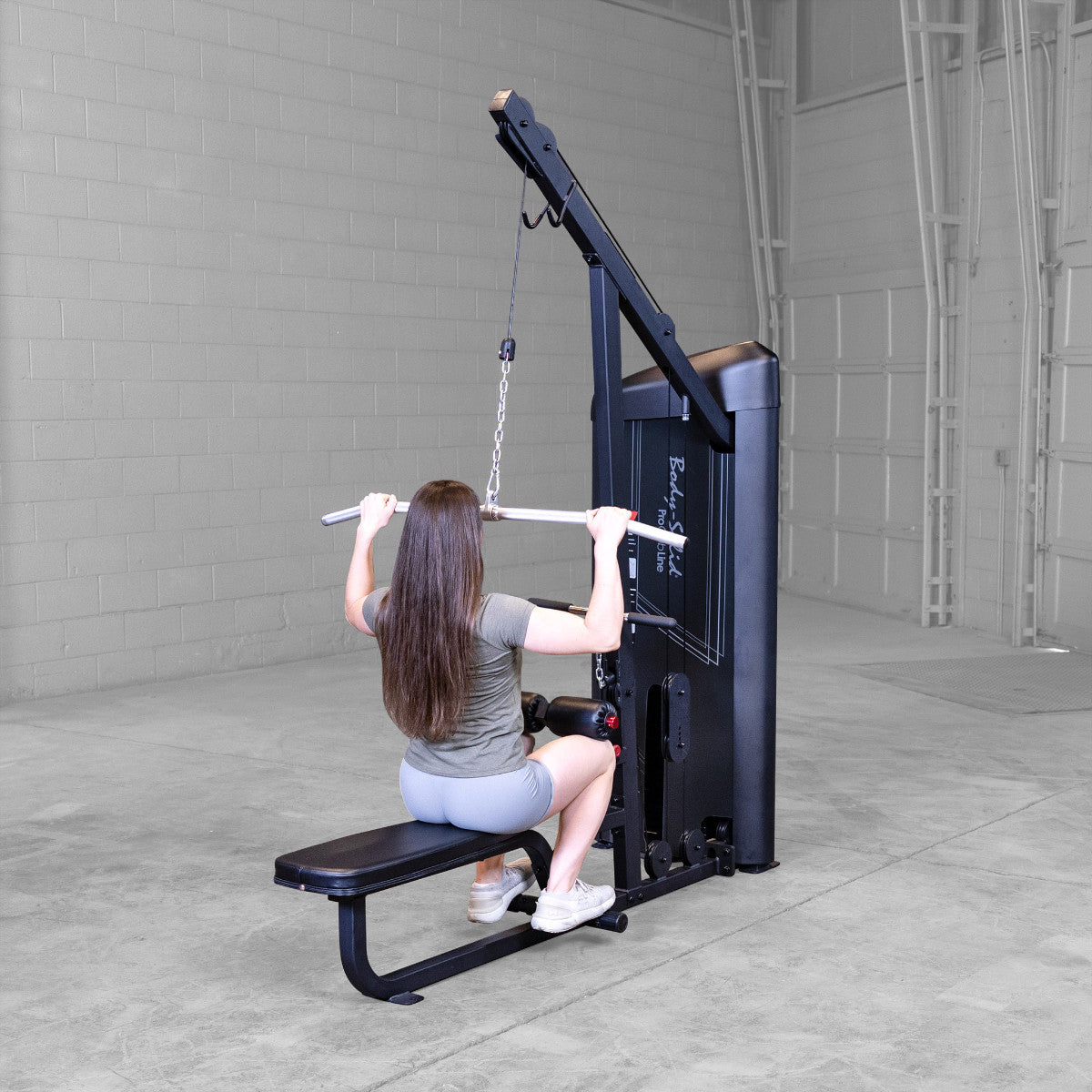 Body-Solid S2LATX Pro ClubLine Series 2 Dual Lat & Seated Row Machine with woman exercising