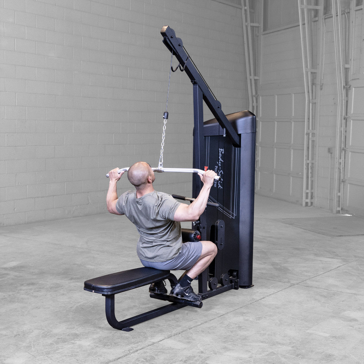 Body-Solid S2LATX Pro ClubLine Series 2 Dual Lat & Seated Row Machine with man exercising