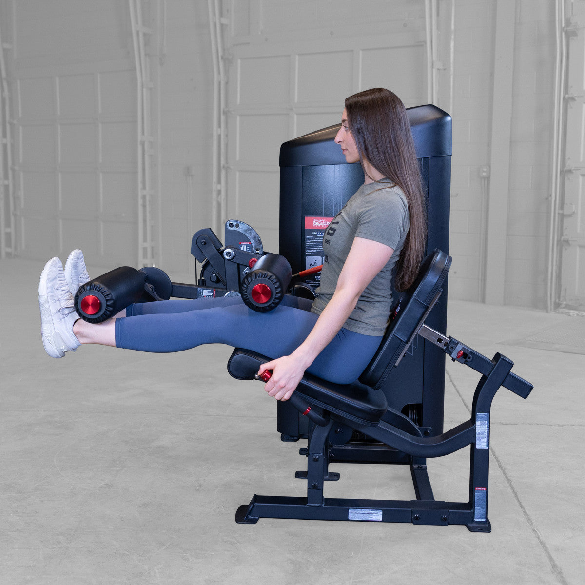 Body-Solid S2LECX Pro ClubLine Series 2 Dual Leg Curl & Extension Machine in gym with woman exercising