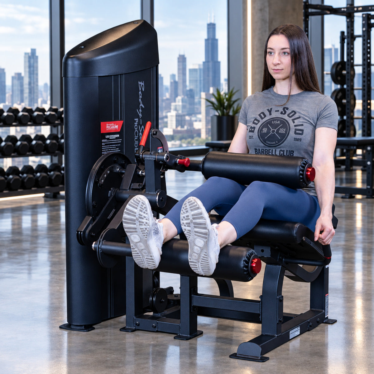 Body-Solid S2LECX Pro ClubLine Series 2 Dual Leg Curl & Extension Machine in gym with woman exercising
