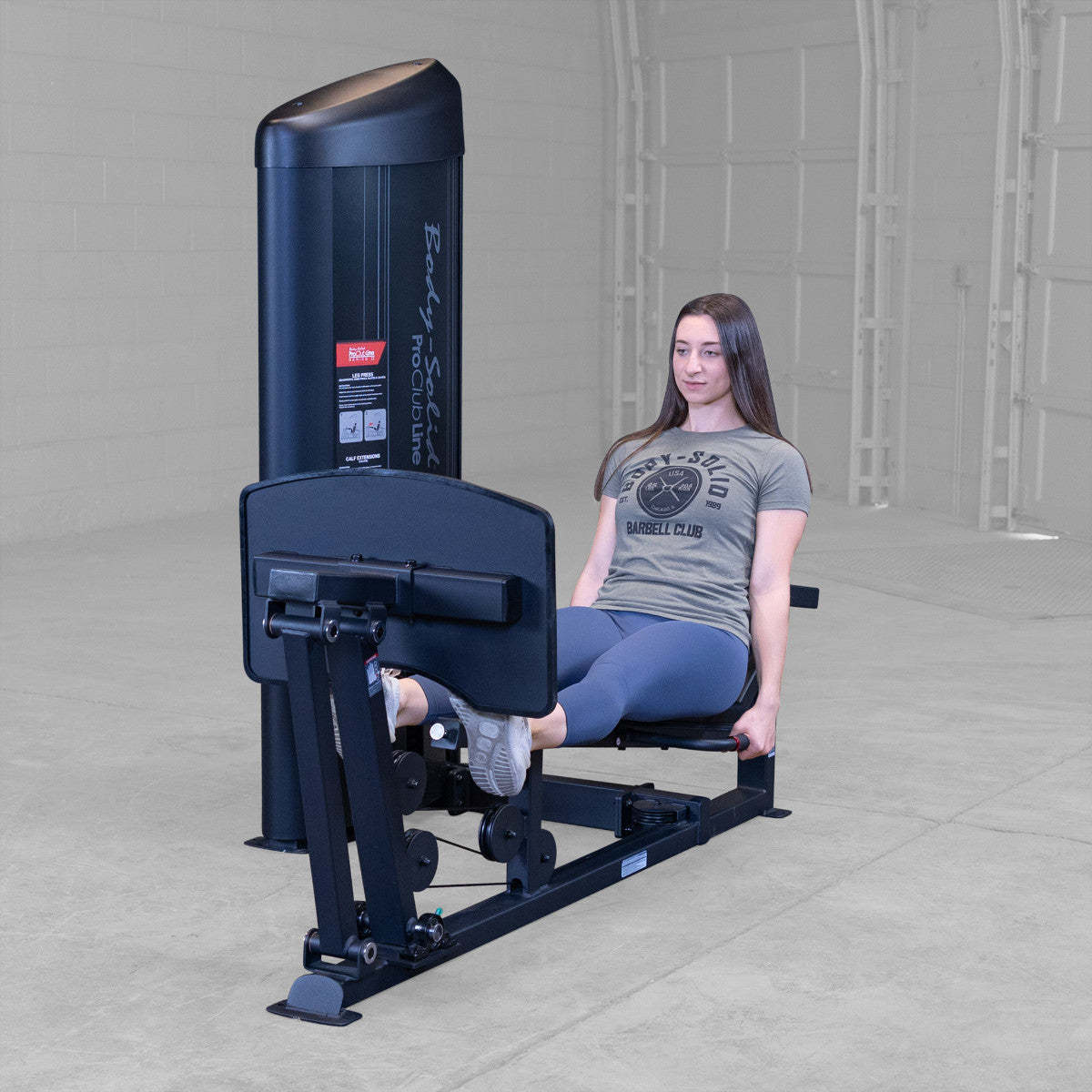 Body-Solid S2LPCX Pro ClubLine Series 2 Leg & Calf Press in gym with woman exercising.