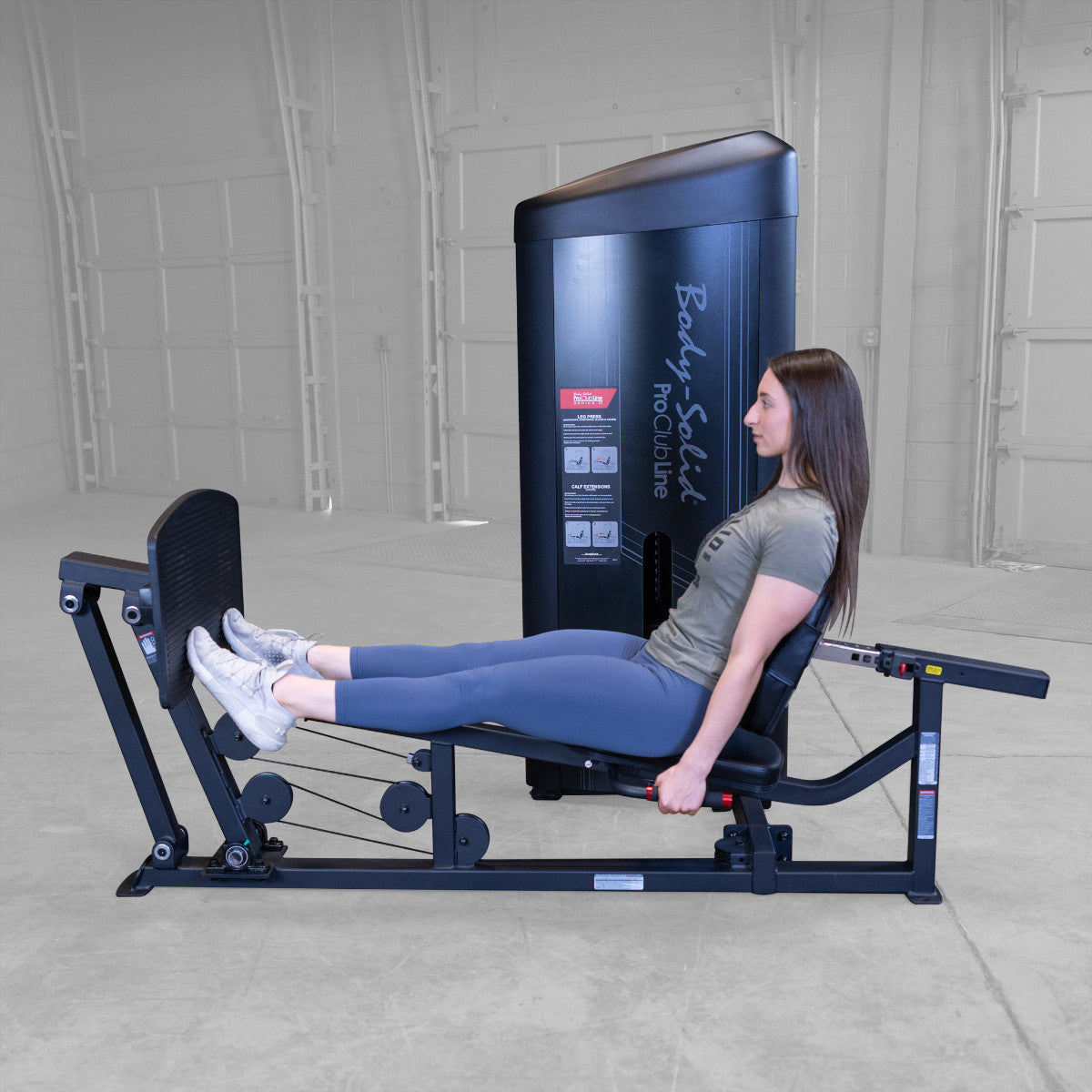 Body-Solid S2LPCX Pro ClubLine Series 2 Leg & Calf Press in gym with woman exercising.