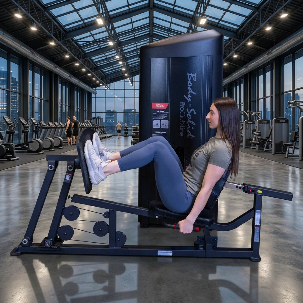 Body-Solid S2LPCX Pro ClubLine Series 2 Leg & Calf Press in gym with woman exercising.