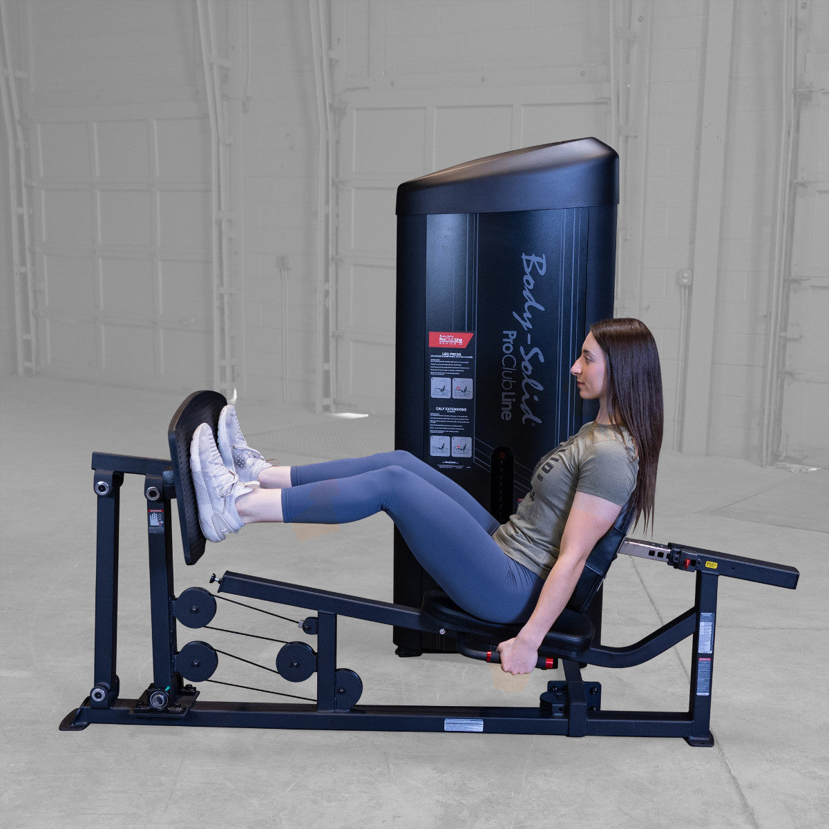 Body-Solid S2LPCX Pro ClubLine Series 2 Leg & Calf Press in gym with woman exercising.