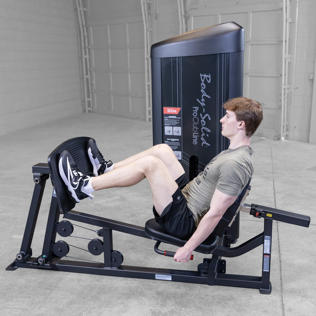 Body-Solid S2LPCX Pro ClubLine Series 2 Leg & Calf Press in gym with man exercising.