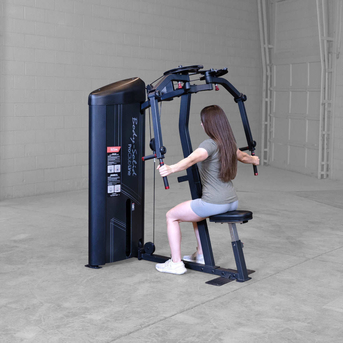Body-Solid S2PECX Pro ClubLine Series 2 Dual Pec Fly & Rear Delt Machine in gym with woman exercising