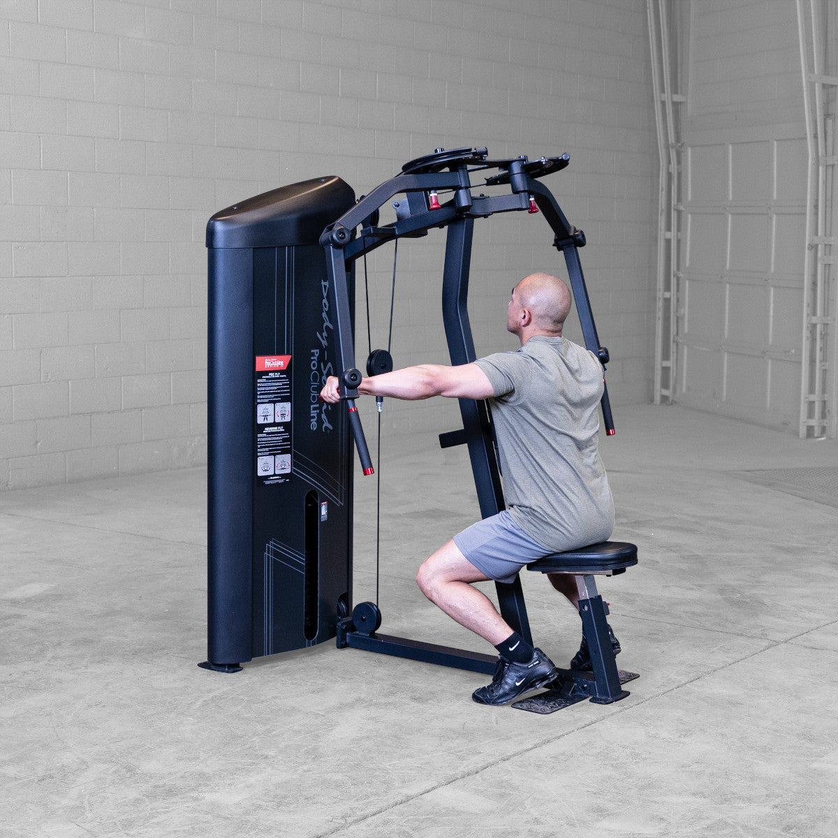 Body-Solid S2PECX Pro ClubLine Series 2 Dual Pec Fly & Rear Delt Machine in gym with man exercising