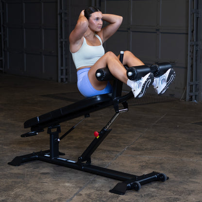 Body-Solid SAB500B Pro ClubLine Adjustable Decline Ab Bench in gym with woman doing ab crunches