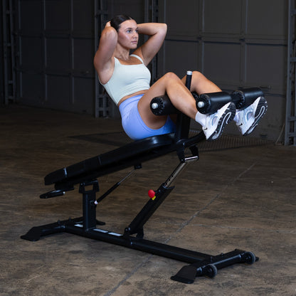 Body-Solid SAB500B Pro ClubLine Adjustable Decline Ab Bench in gym with woman doing ab crunches
