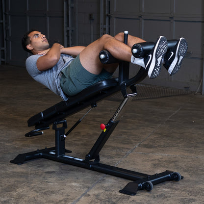 Body-Solid SAB500B Pro ClubLine Adjustable Decline Ab Bench in gym with man doing ab crunches