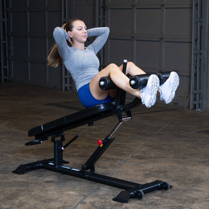 Body-Solid SAB500B Pro ClubLine Adjustable Decline Ab Bench in gym with woman doing ab crunches