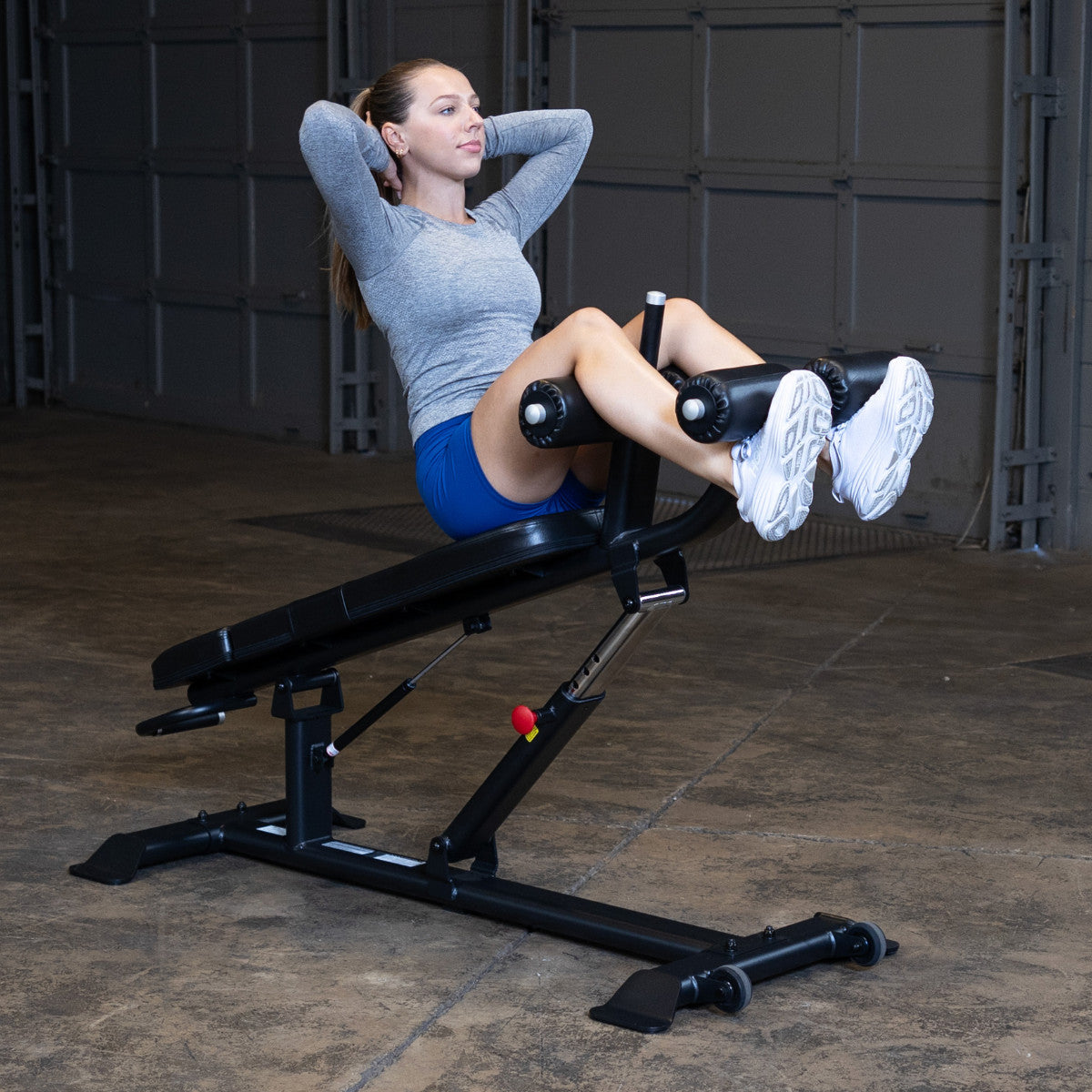 Body-Solid SAB500B Pro ClubLine Adjustable Decline Ab Bench in gym with woman doing ab crunches