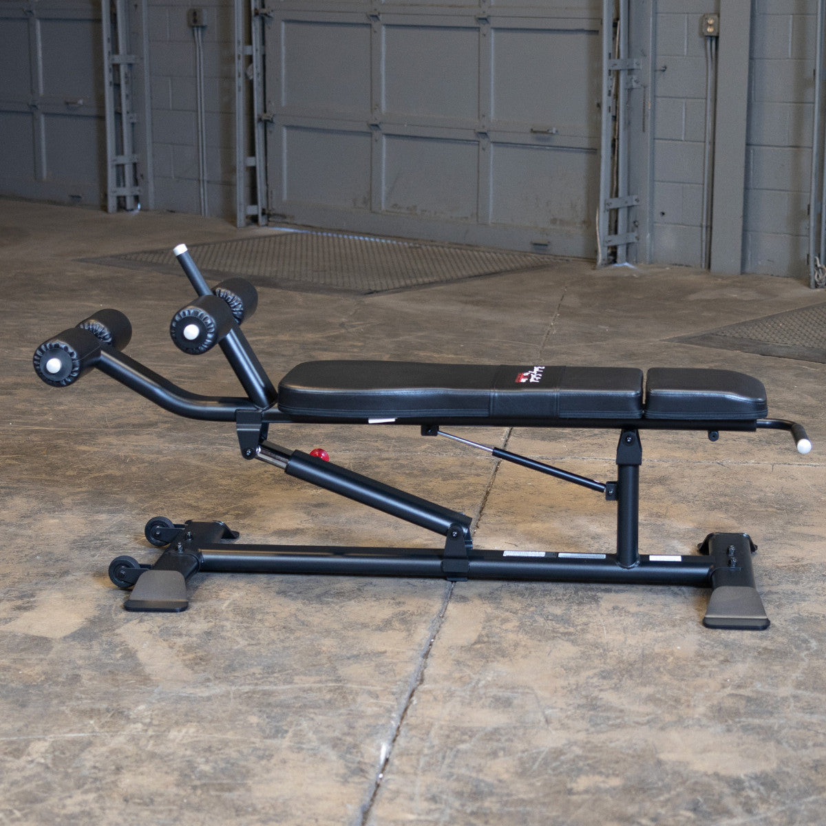 Body-Solid SAB500B Pro ClubLine Adjustable Decline Ab Bench at beach gym with woman doing ab crunches