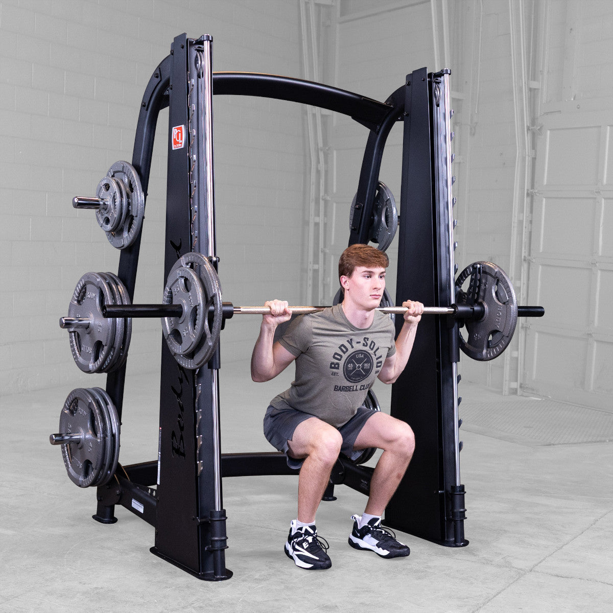 Body-Solid Pro ClubLine SCB1000B Counter Balanced Smith Machine man exercising