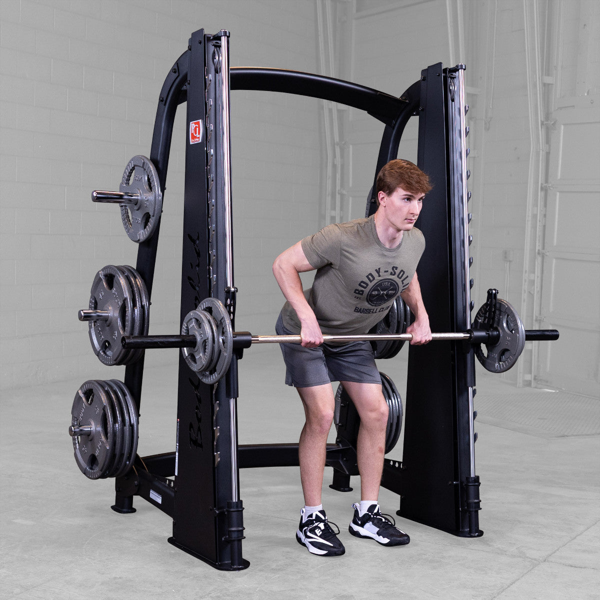 Body-Solid Pro ClubLine SCB1000B Counter Balanced Smith Machine man exercising