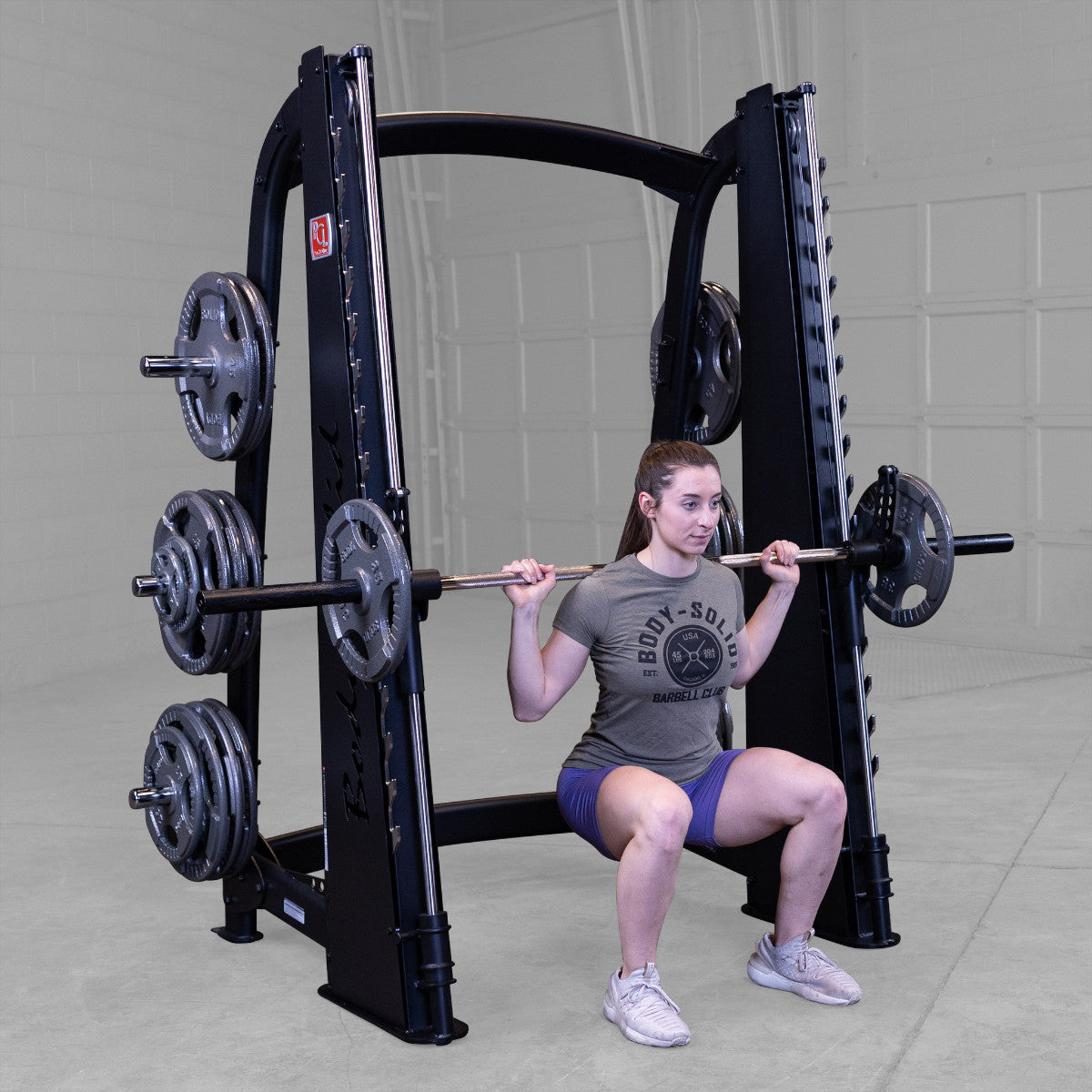 Body-Solid Pro ClubLine SCB1000B Counter Balanced Smith Machine woman exercising