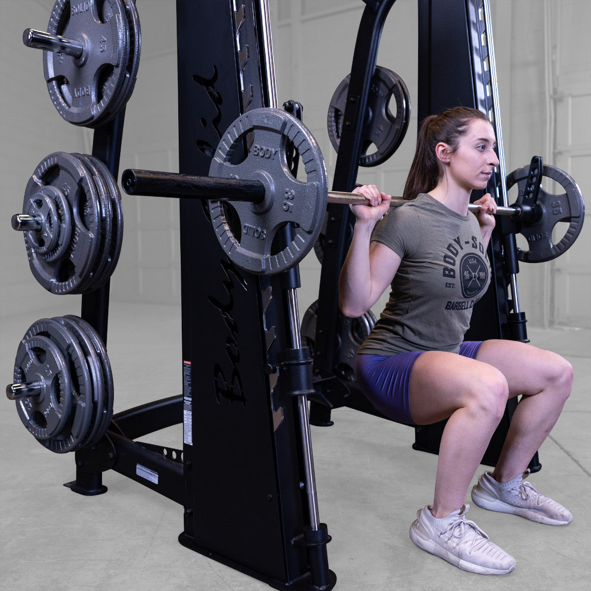 Body-Solid Pro ClubLine SCB1000B Counter Balanced Smith Machine woman exercising