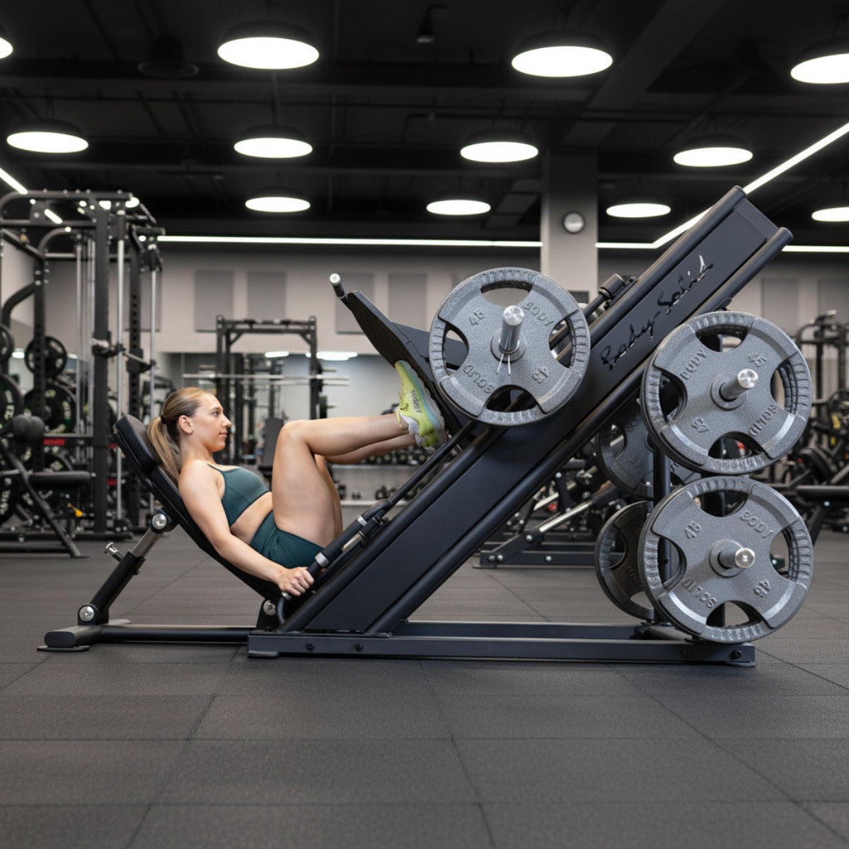 Body-Solid Pro Clubline SGLP500 Leg Press with woman exercising in gym