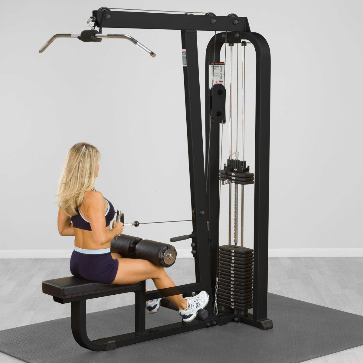 Body Solid SLM300B Pro ClubLine Lat Pulldown & Row Machine in gym with woman exercising