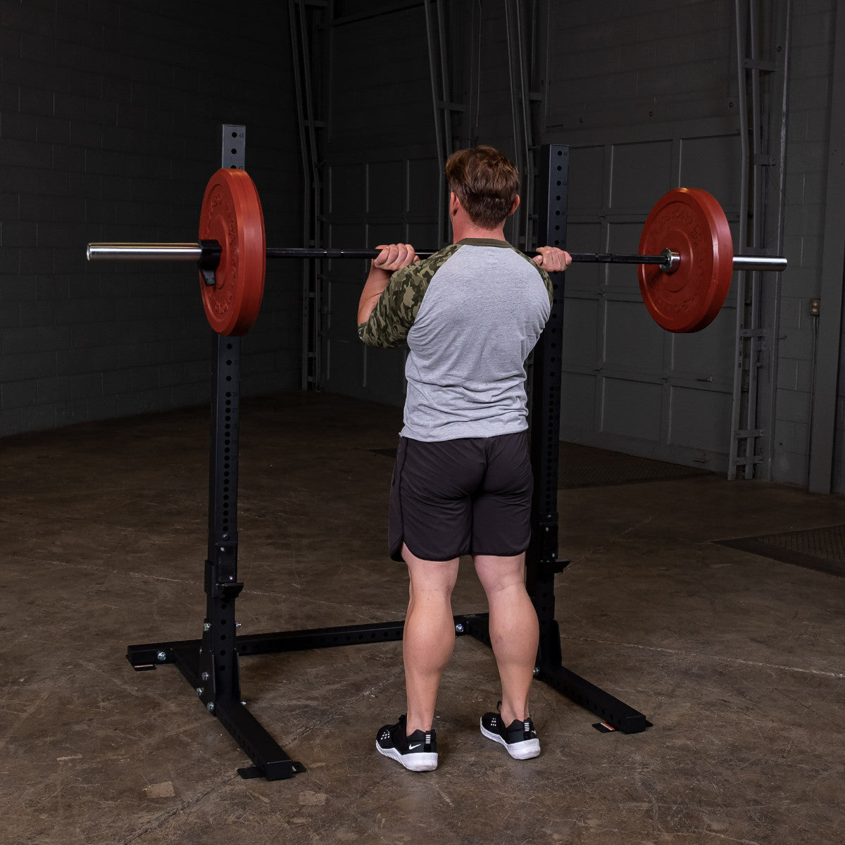 Body-Solid Pro ClubLine SPR250 Squat Rack man exercising