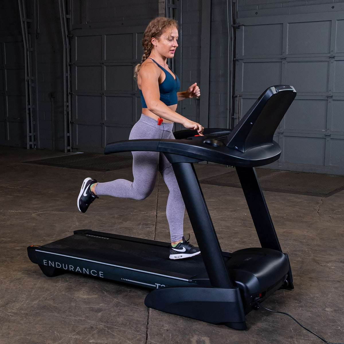 Body-Solid Endurance T25 Folding Treadmill woman running