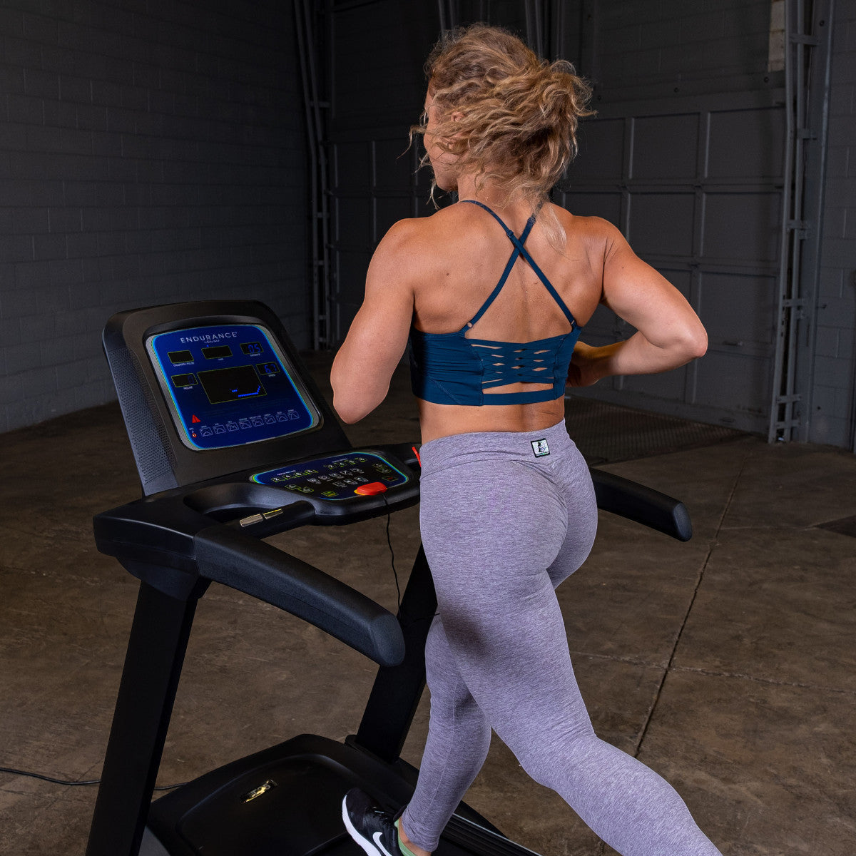 Body-Solid Endurance T25 Folding Treadmill woman running
