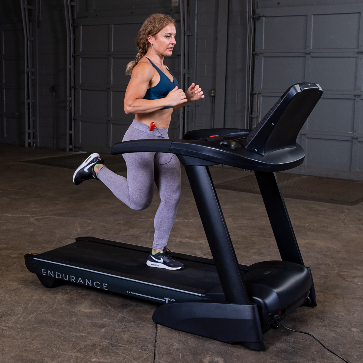 Body-Solid Endurance T25 Folding Treadmill woman running