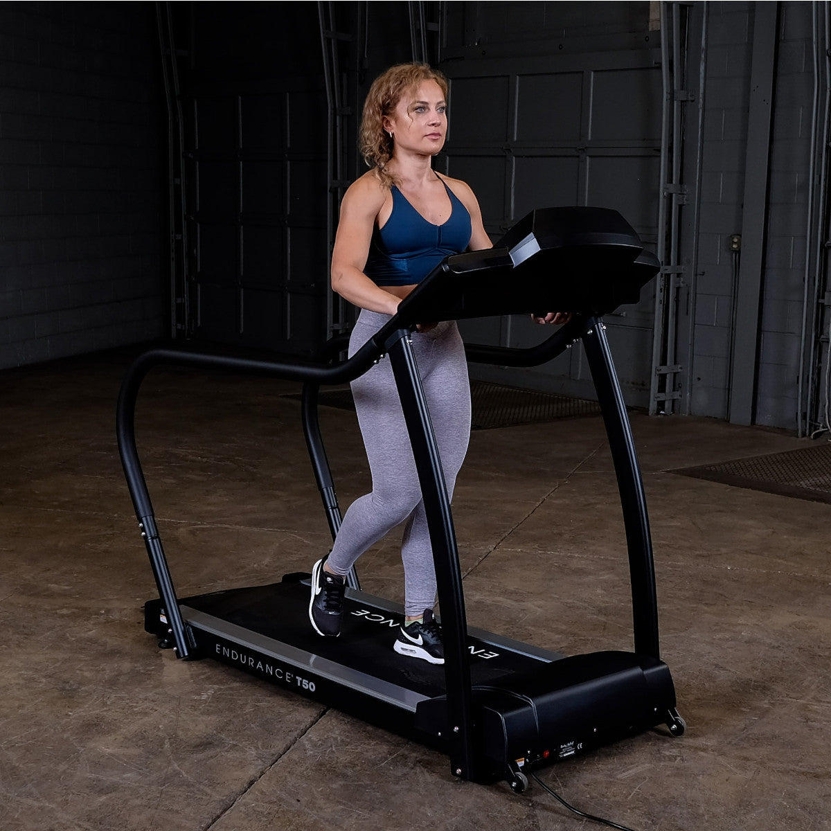 Body-Solid Endurance T50 Walking Treadmill with woman walking
