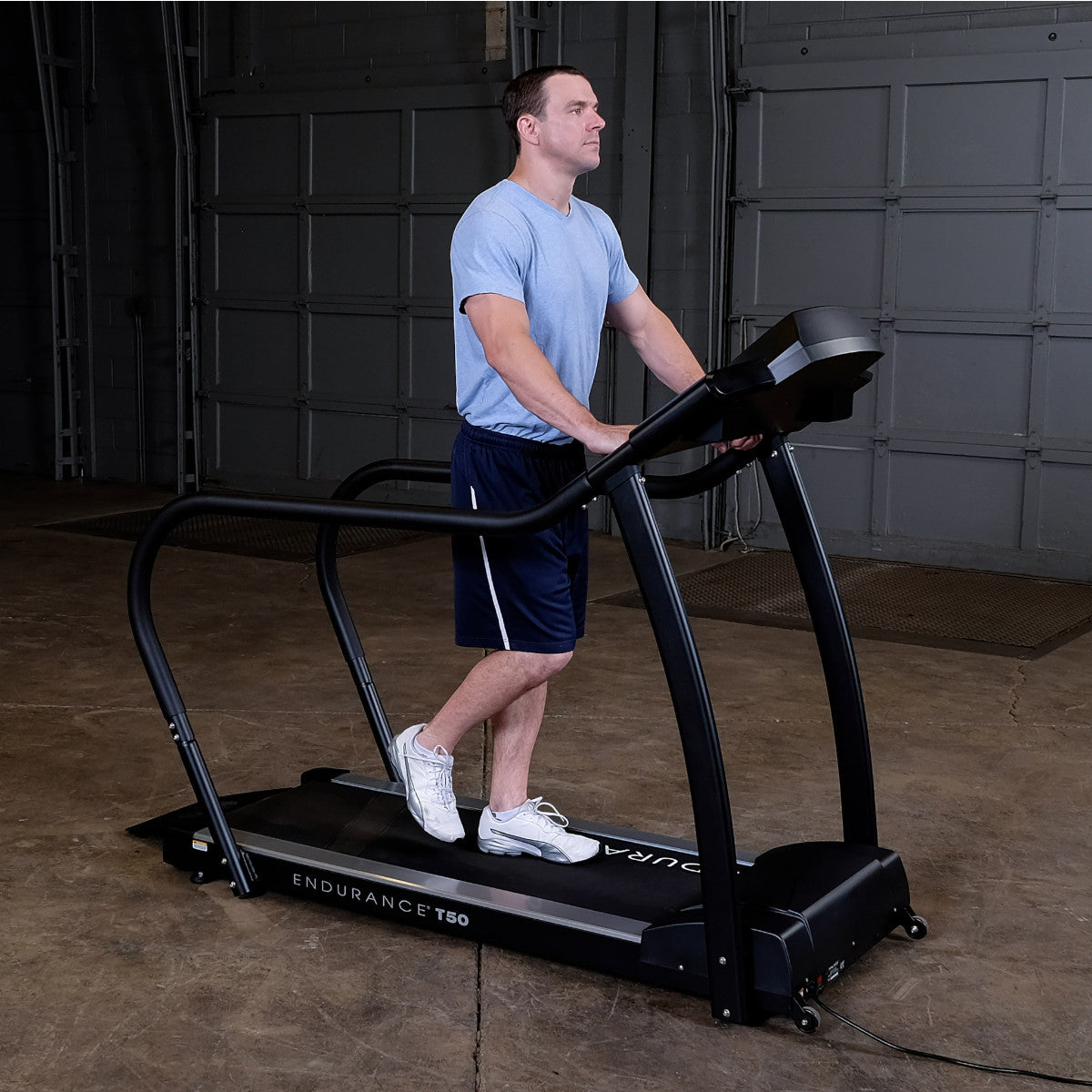Body-Solid Endurance T50 Walking Treadmill with man walking