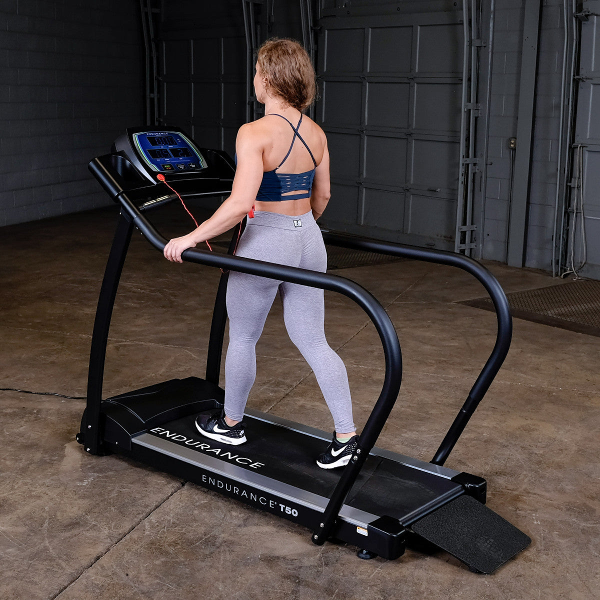 Body-Solid Endurance T50 Walking Treadmill with woman walking