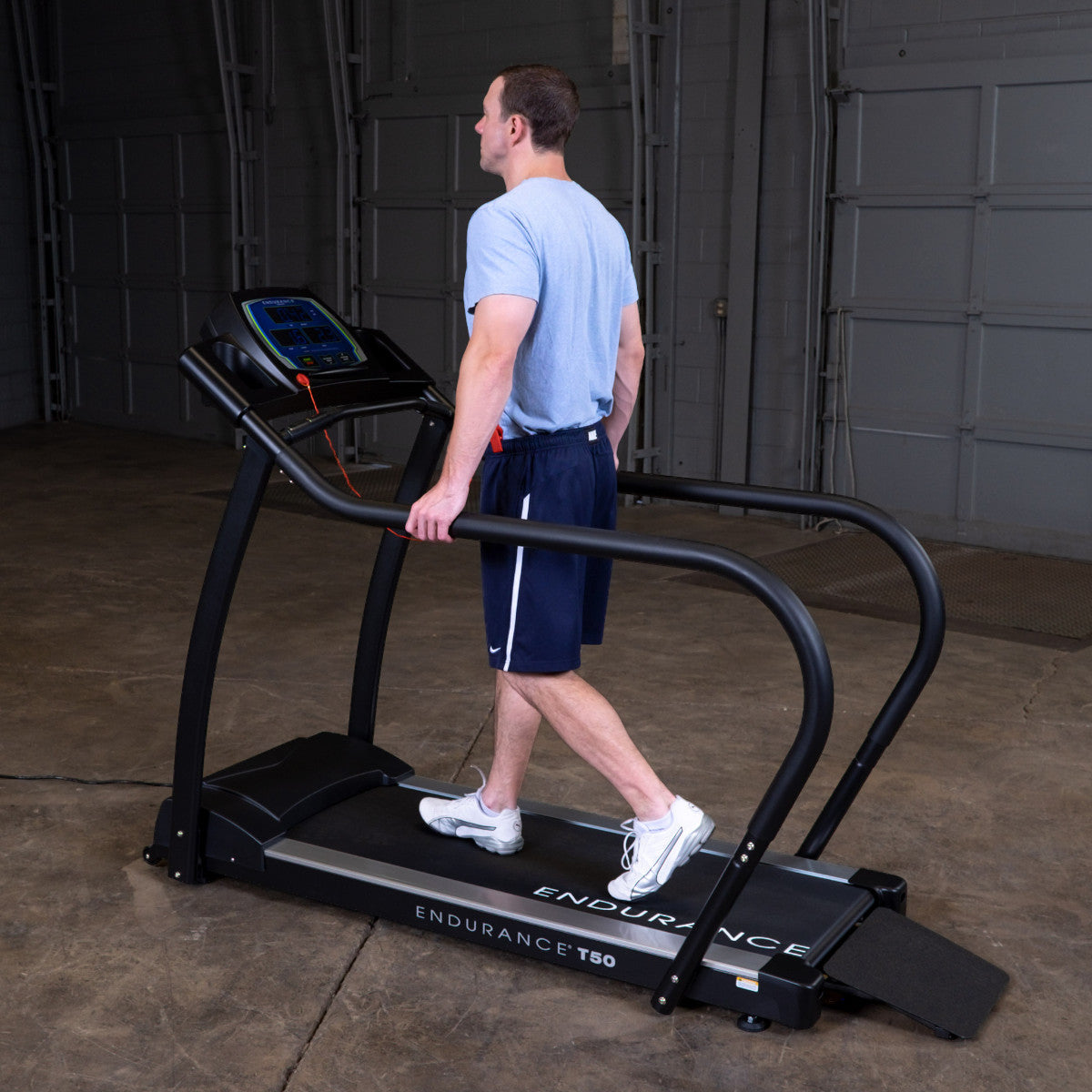 Body-Solid Endurance T50 Walking Treadmill with man walking