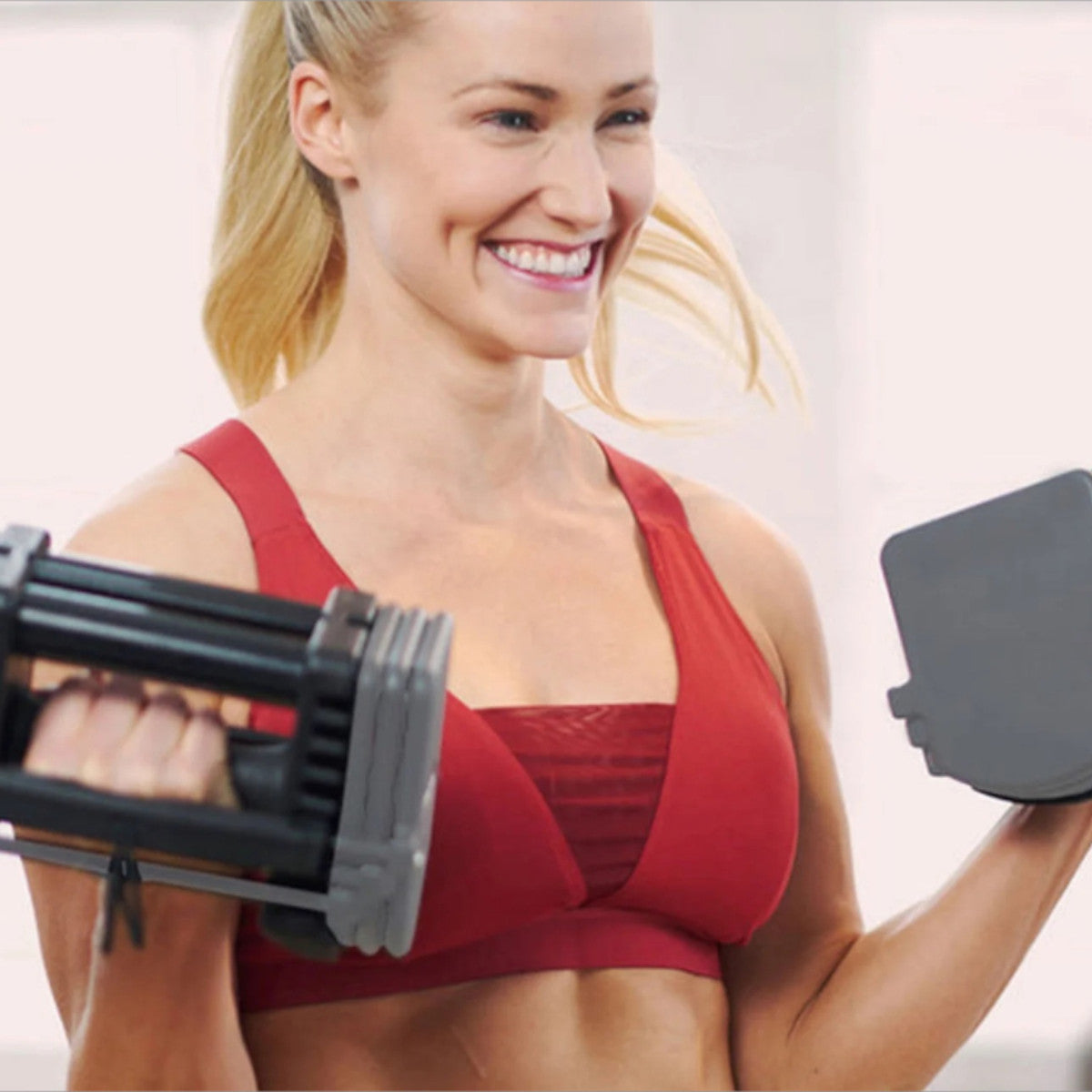 Pair of Gray PowerBlock Sport 24 with woman working out