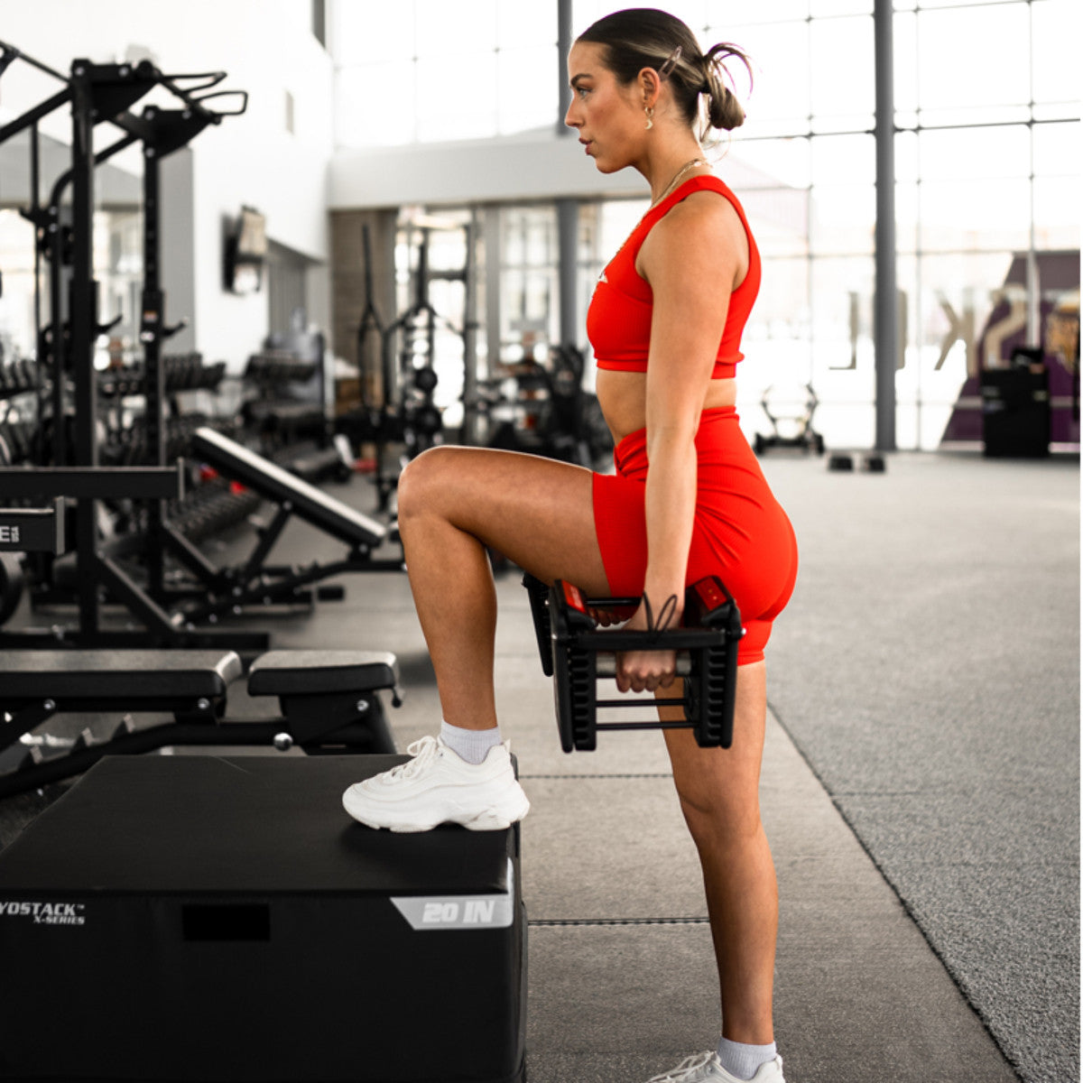 Woman using PowerBlock Pro 100 in a gym.