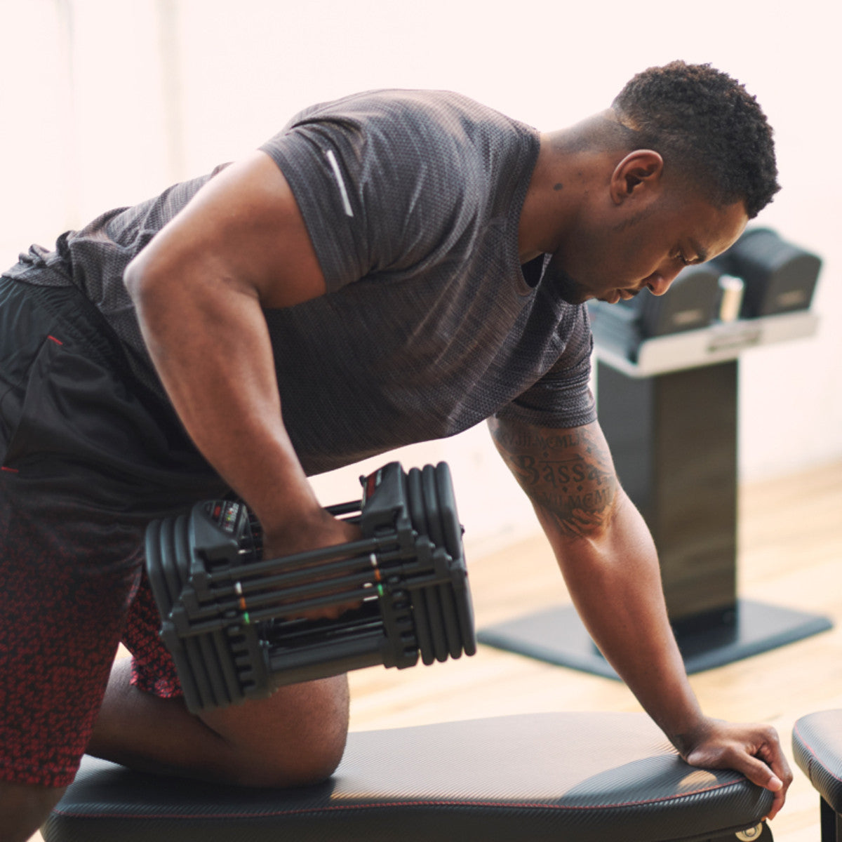 PowerBlock Pro 50 Adjustable Dumbbell back-pull exercise.