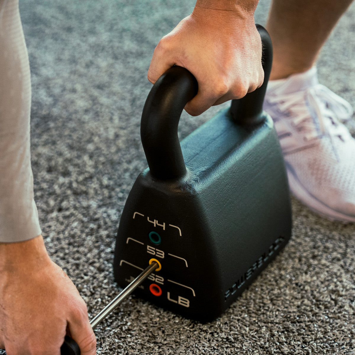 PowerBlock Pro Adjustable Kettlebell 35-62 LB pin weight adjustment.