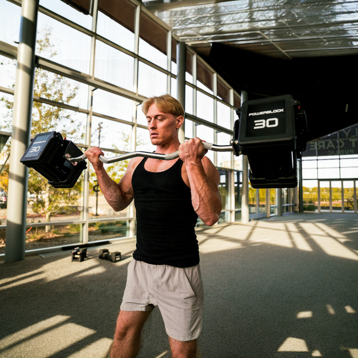 PowerBlock Pro 100 EXP EZ Curl Barbell bicep curl exercise.
