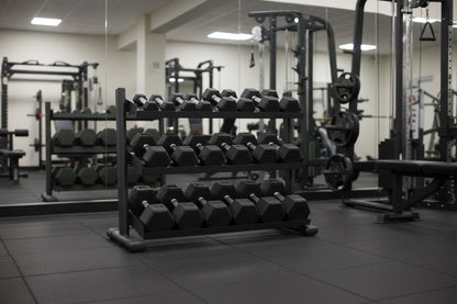 TKO S6235-TXRA10 5 to 50LB Tri-Grip Rubber Hex Dumbbell Set w/Rack in gym