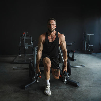 TKO 718LD Signature Plate Loaded Universal Lunge Deadlift Shrug - man performing lunge exercise.