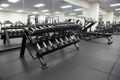 TKO S889-TXRA10 5 to 50LB Tri-Grip Rubber Hex Dumbbell Set w/Rack angle view at gym