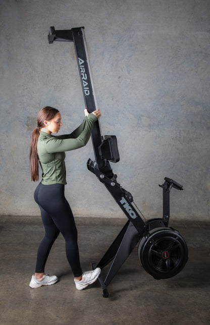 Woman standing up TKO 8AR AirRaid Rowing machine with a stand