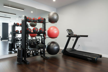 Gym room with TKO exercise balls, kettlebells, and a treadmill.